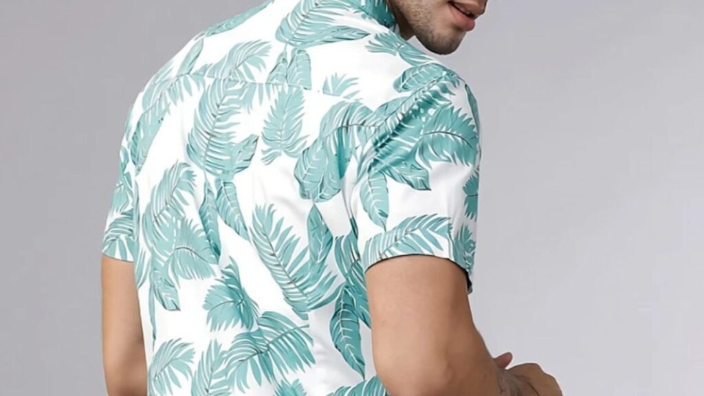 wearing a light floral shirt, with sunlight filtering through the trees